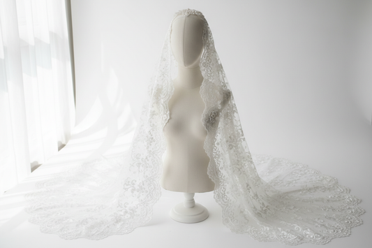 Delicate white lace wedding veil, fingertip length, intricate floral lace pattern, elegant bridal accessory